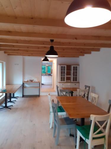 a dining room with wooden tables and chairs at Casa Mara Viseu de Sus in Vişeu de Sus