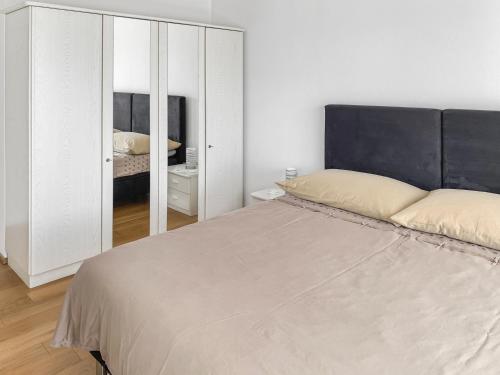 a bedroom with a large bed and a mirror at Haus zur Lilie in Hinwil