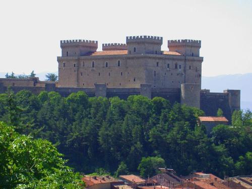 a large castle on top of a hill with trees at La Villa dei Tartufi - B&B in Corfinio