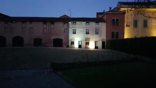 an old building at night with the lights on at Corte Ramedello in Cerea