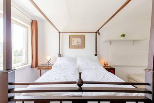a bedroom with a large bed with a wooden frame at Apartment Untere Donaustrasse in Vienna