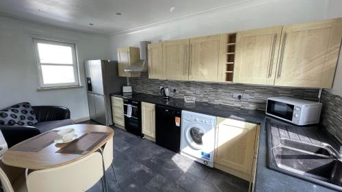 a kitchen with a washer and dryer in a room at North Middleton Apartment in North Middleton