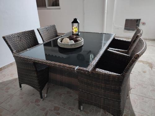 a glass table with chairs and a candle on top at Villa Flora in Afantou