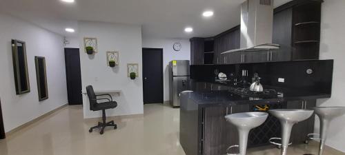 a kitchen with a counter and a sink and a chair at Equilibrio Shalom Living in Medellín