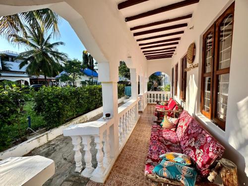 a porch of a house with a couch at Kihori Nungwi in Nungwi