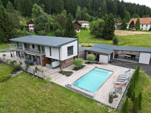 an aerial view of a house with a swimming pool at Villa 4 Saisons, avec piscine chauffée et jacuzzi in Gérardmer