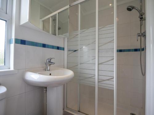 een badkamer met een wastafel en een douche bij The Hideaway in Bridport