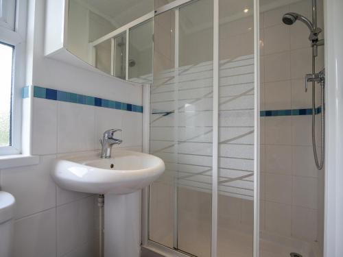 a bathroom with a sink and a shower at The Hideaway in Bridport
