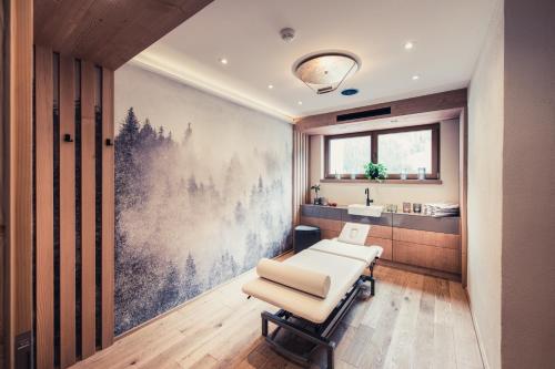 a dentist appointment room with a chair and a sink at Alpenhotel Kramerwirt in Mayrhofen