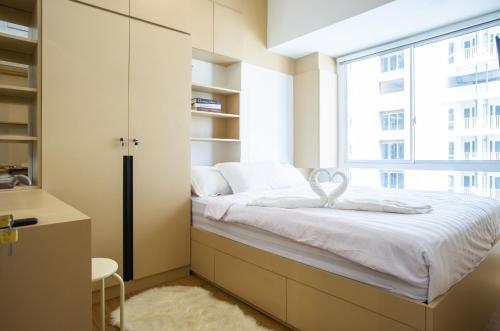 a bed in a room with a window at Tokyo Riverside Apartment @ PIK 2 in Tangerang