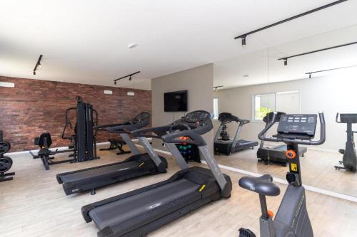 a gym with several treadmills and exercise bikes at Brás estudio confort in Sao Paulo