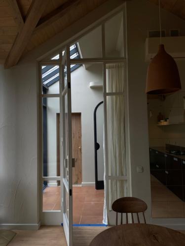 a room with a sliding glass door and a chair at Шале DEREVA in Yablunytsya
