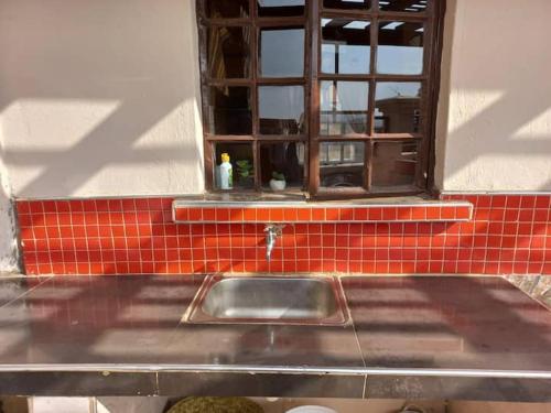 a kitchen sink in front of a window at The Penthouse at Lemiso road in Ngong
