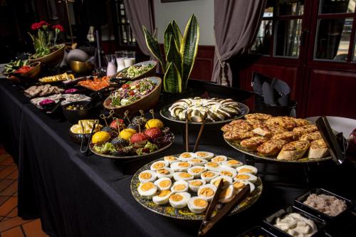 a table with many different types of food on at Senoji Hansa Hotel in Palanga
