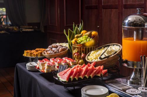 a buffet of food and fruit on a table at Senoji Hansa Hotel in Palanga