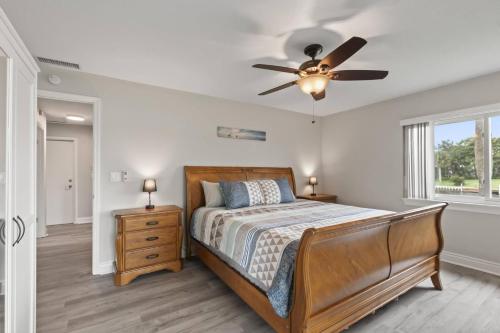 a bedroom with a bed and a ceiling fan at Campbell Ct Anchors Landing Waterfront Home Palm Coast Canal View in Palm Coast