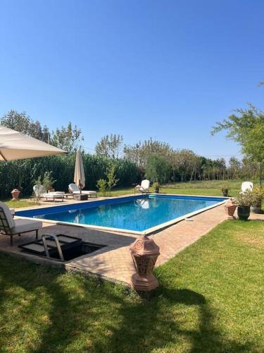 a large swimming pool in a yard with at dream farm in Marrakesh