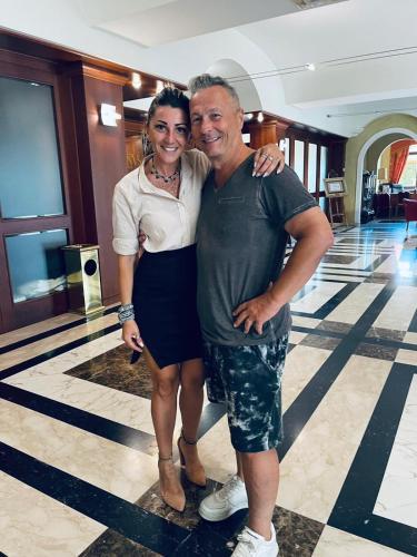 a man and a woman posing for a picture in a lobby at Hotel Villa Venus Resort & SPA in Atena Lucana