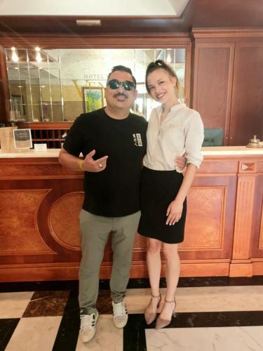 a man and a woman standing in front of a counter at Hotel Villa Venus Resort & SPA in Atena Lucana