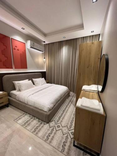 1 dormitorio con 1 cama grande y espejo en وجا هوستلز A101 دار الصفاء 47, en Riad