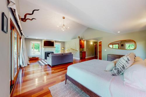 a bedroom with a bed and a living room at Emerald Acres in McKinleyville