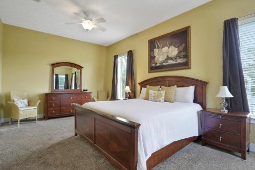 a bedroom with a large bed and a mirror at The Lighthouse in Panama City Beach