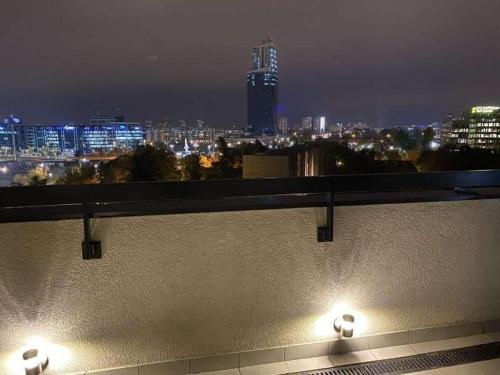 a city skyline at night with lights on a building at Skyline in Belgrade