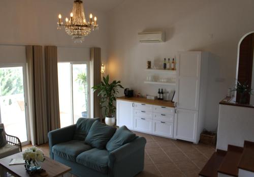 a living room with a couch and a kitchen at Casa Carioca Carvoeiro in Carvoeiro