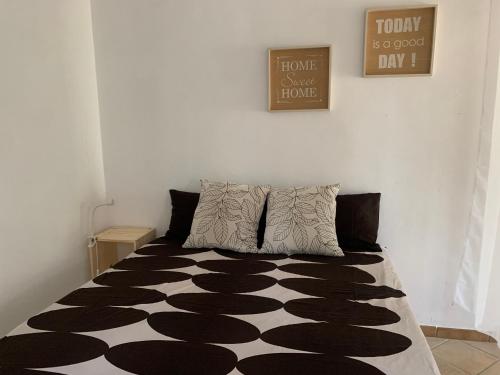 a bedroom with a bed with a black and white floor at Green Garden Oasi in Cinisi