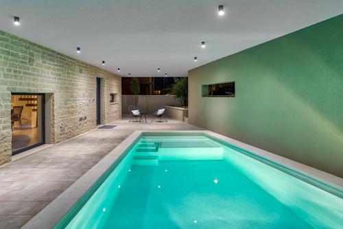 a swimming pool in the middle of a house at Villa Sponza in Medulin