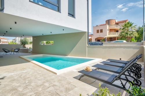 a swimming pool in the backyard of a house at Villa Sponza in Medulin