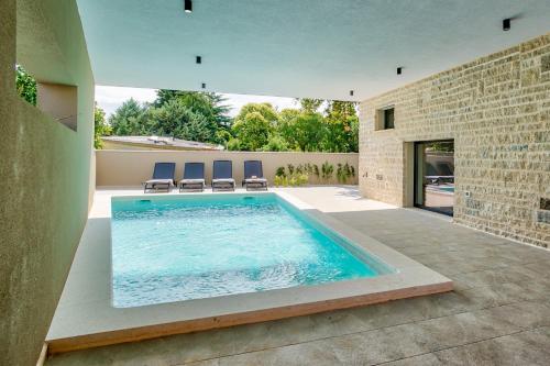 a swimming pool in the middle of a house at Villa Sponza in Medulin