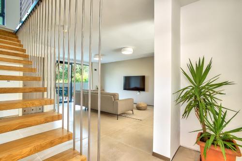 a living room with a staircase and a couch at Villa Sponza in Medulin