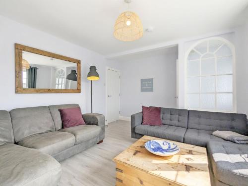 a living room with two couches and a table at Grace Cottage - Emsworth in Emsworth