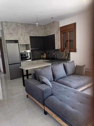 a living room with a couch and a kitchen at Athor Ireon Apartment 1 in Ireon