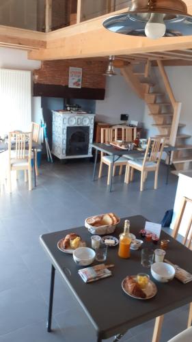 a table with plates of food on it in a kitchen at LES GALAINES in Abzac