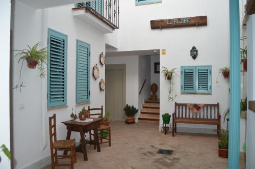 a courtyard with a table and chairs in a house at Apartamentos El Aljibe Relax Tourist Cordoba in Córdoba