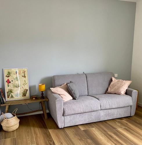 a gray couch in a living room with a table at ORO, 8 in Bellano