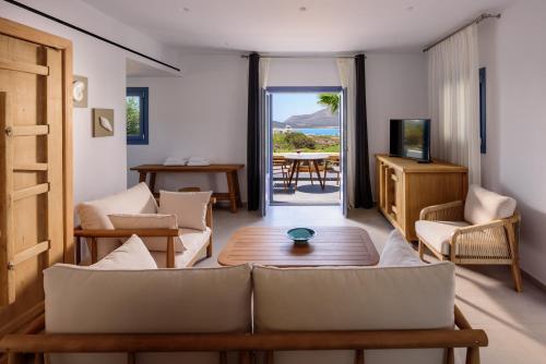 a living room with a couch and a table at White Dream Suites Antiparos in Andiparos