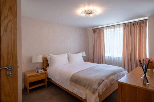 a bedroom with a large bed and a window at Harbour View in Lymington