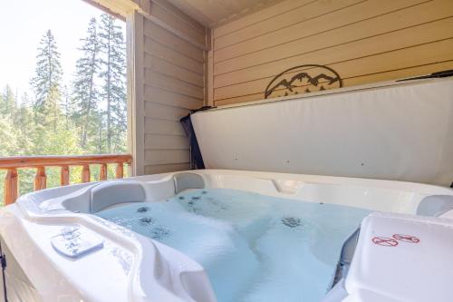 a jacuzzi tub in a room with a balcony at Stone Creek Chalets by Fernie Central Reservations in Fernie
