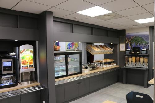 a bakery with a counter with food in it at Campanile Metz Nord - Woippy- Porte du Luxembourg A31 in Woippy