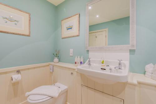 a bathroom with a sink and a toilet at Tiger Inn - Grace in Eastbourne