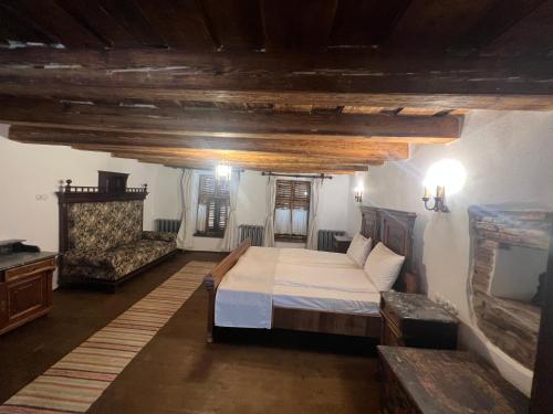 a bedroom with a large bed and a couch at Castle View in Saschiz