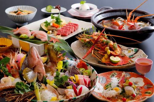 a table full of different types of food on plates at Kaikatei Hanagozen in Kyotango