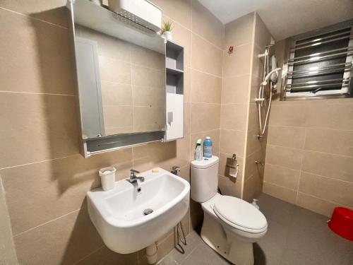 a bathroom with a white toilet and a sink at PANGSAPURI MIDAS in Johor Bahru