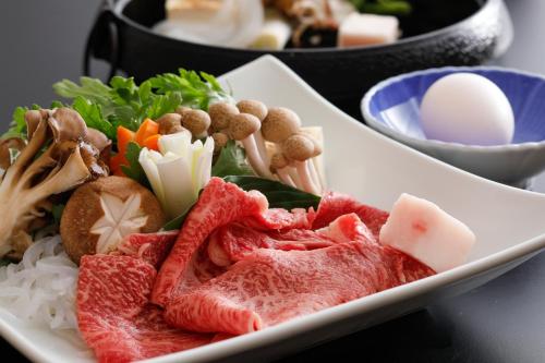 a plate of food with meat rice and vegetables at Kaikatei Hanagozen in Kyotango