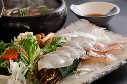 a plate of food with meat and vegetables on a table at Kaikatei Hanagozen in Kyotango