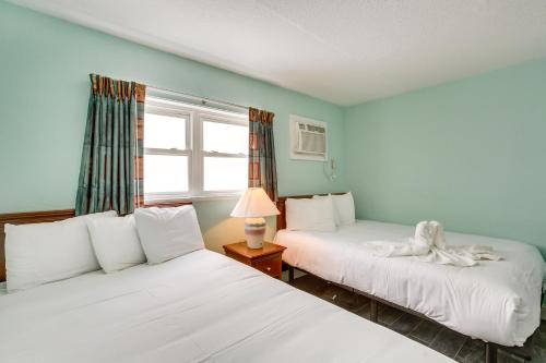 a bedroom with two beds and a window at Wildwood Condo with Pool Access - Walk to Beach! in Wildwood