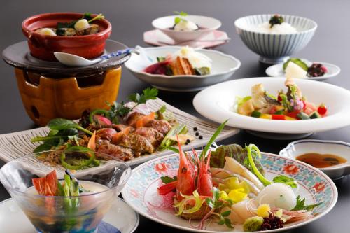 a table with plates of food and bowls of food at Kaikatei Hanagozen in Kyotango